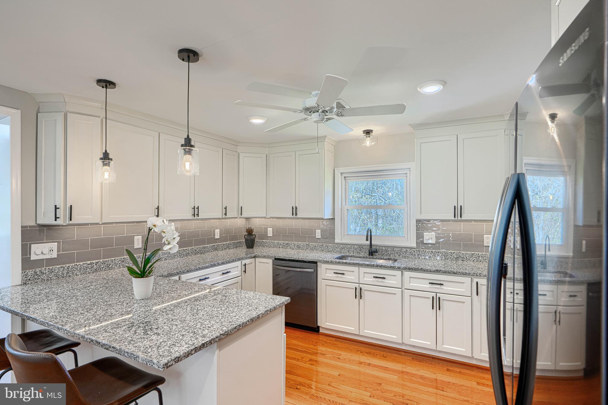 802 Stone Barn Road Towson, MD 21286 - Photo 42 of 104 a kitchen with stainless steel appliances granite countertop a sink a stove and a refrigerator