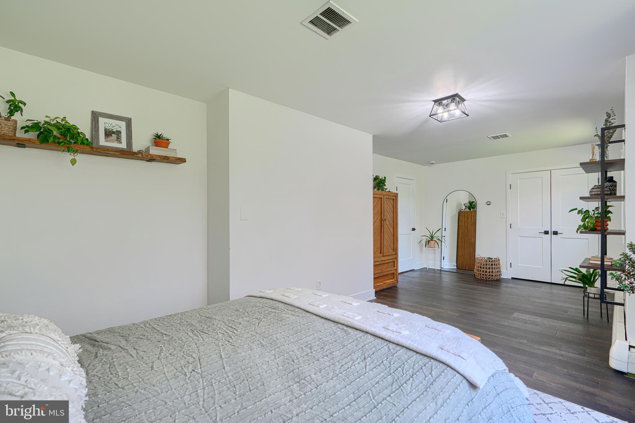 802 Stone Barn Road Towson, MD 21286 - Photo 55 of 104 a bedroom with a bed and a chandelier