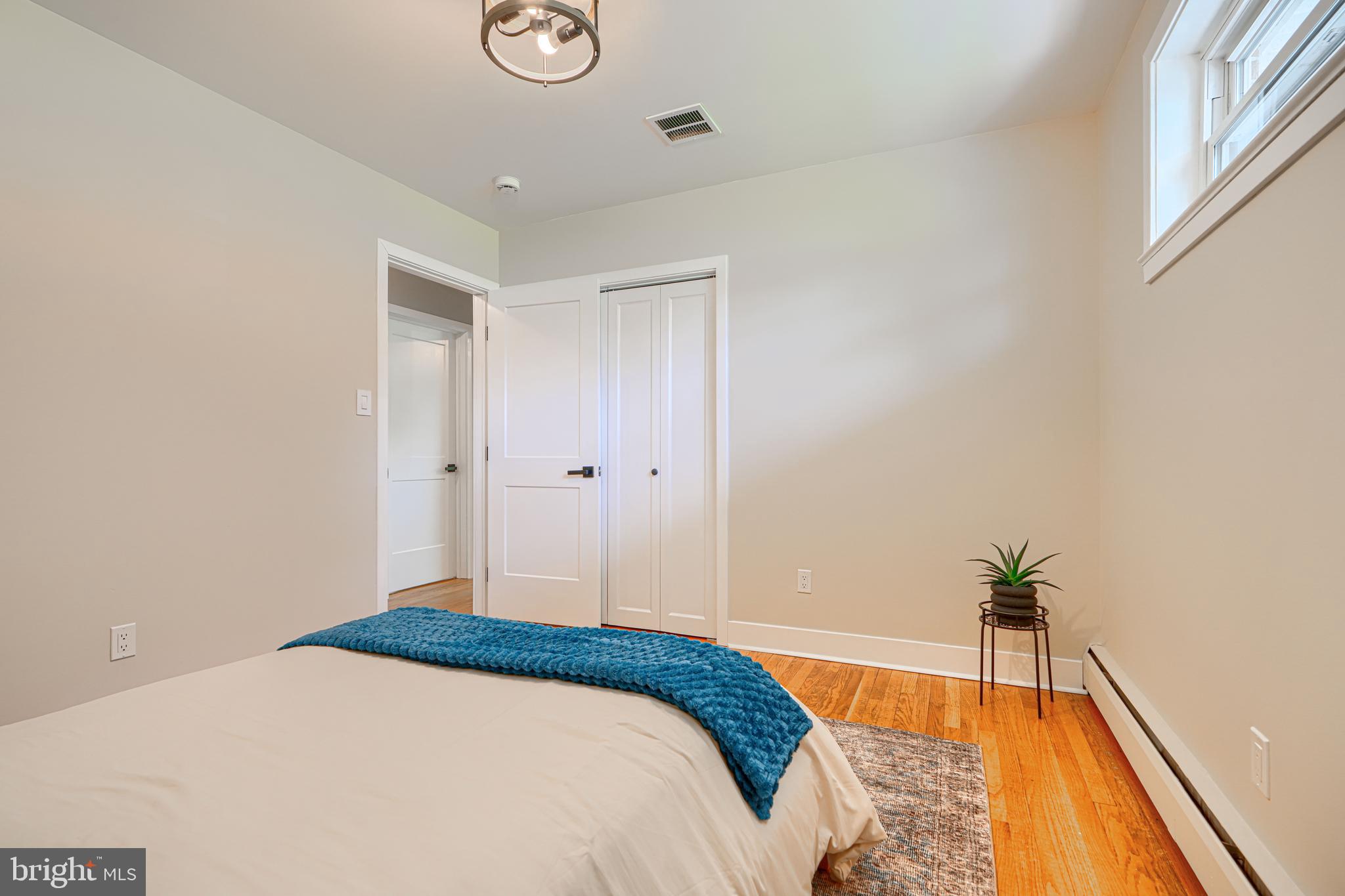 802 Stone Barn Road Towson, MD 21286 - Photo 59 of 104 a bedroom with a bed and a potted plant
