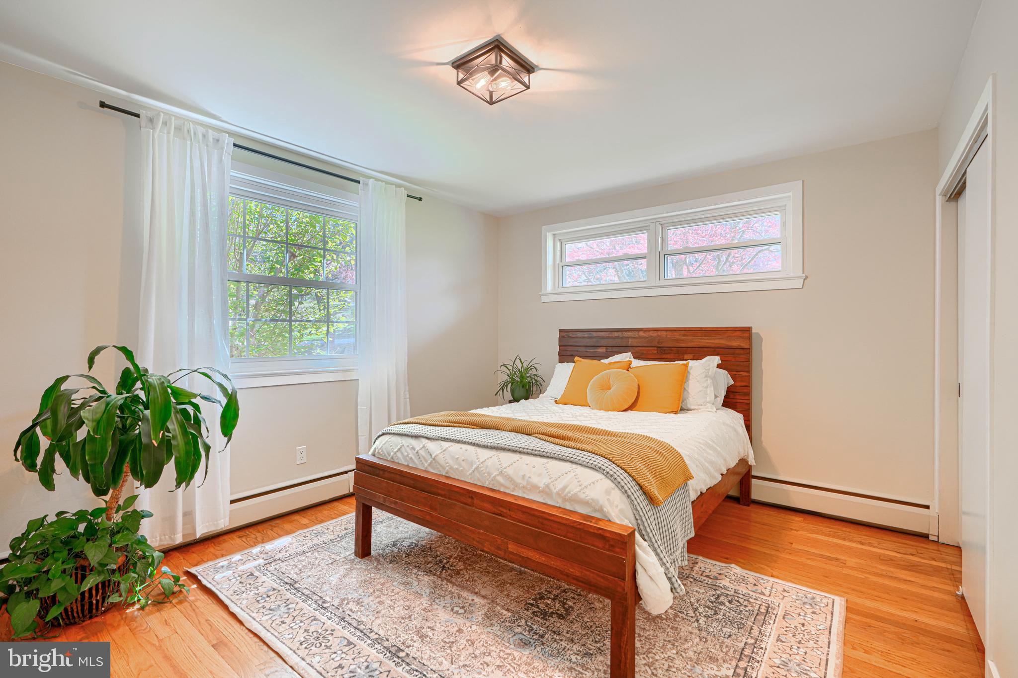 802 Stone Barn Road Towson, MD 21286 - Photo 61 of 104 a bedroom with a bed and a potted plant