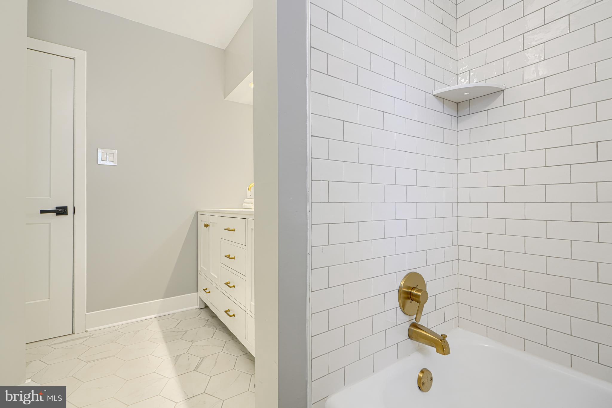 802 Stone Barn Road Towson, MD 21286 - Photo 65 of 104 a bathroom with a tub and a sink