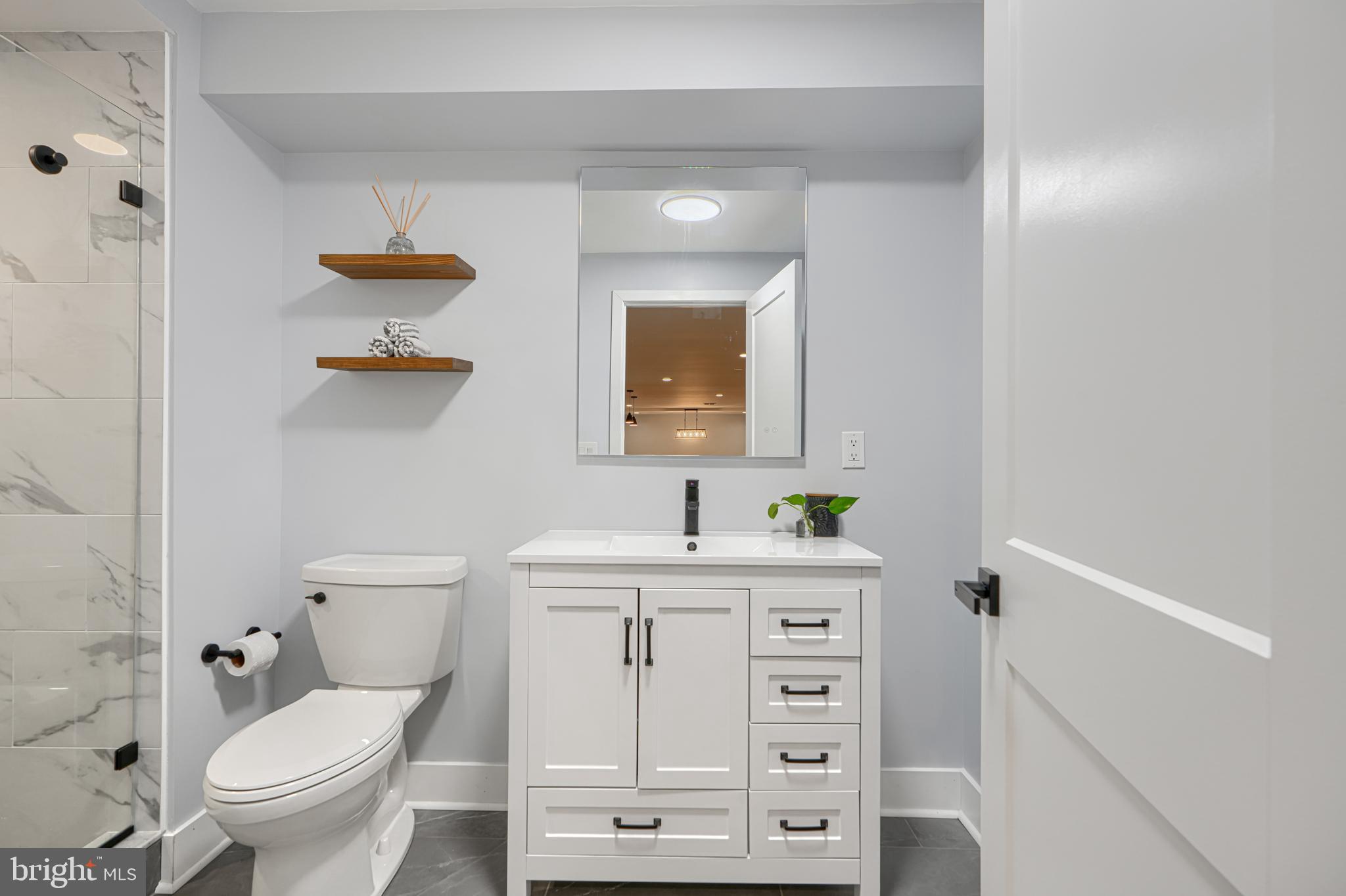 802 Stone Barn Road Towson, MD 21286 - Photo 86 of 104 a bathroom with a toilet a sink and mirror