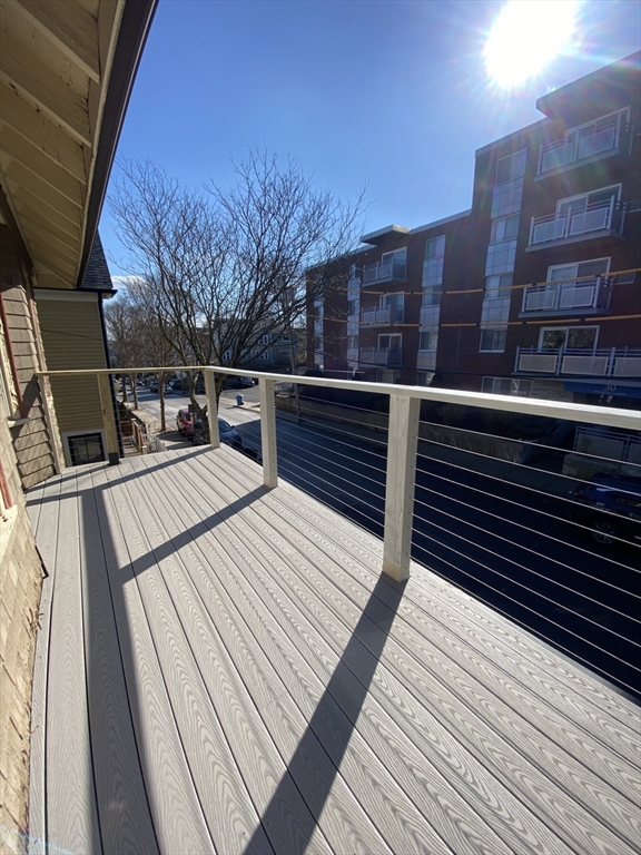 33 Iroquois Street, Unit 2 Boston, MA 02120 - Photo 12 of 14 a view of a balcony with wooden floor and city view