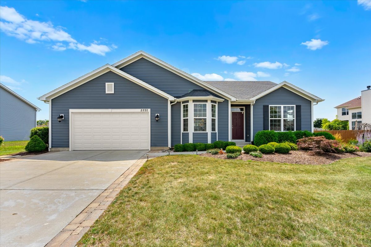 a front view of house with yard and green space