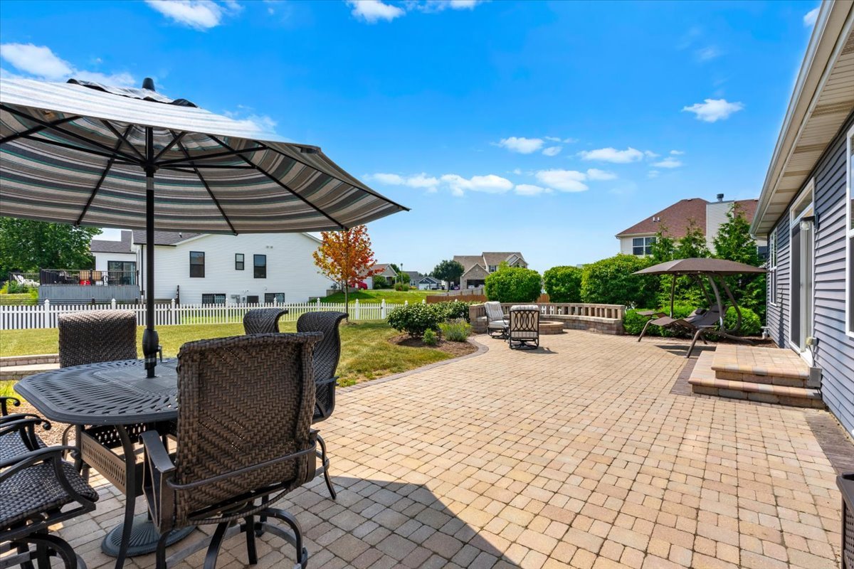 2220 Tyler Trail McHenry, IL 60051 - Photo 17 of 24 a view of a patio with a table and chairs under an umbrella