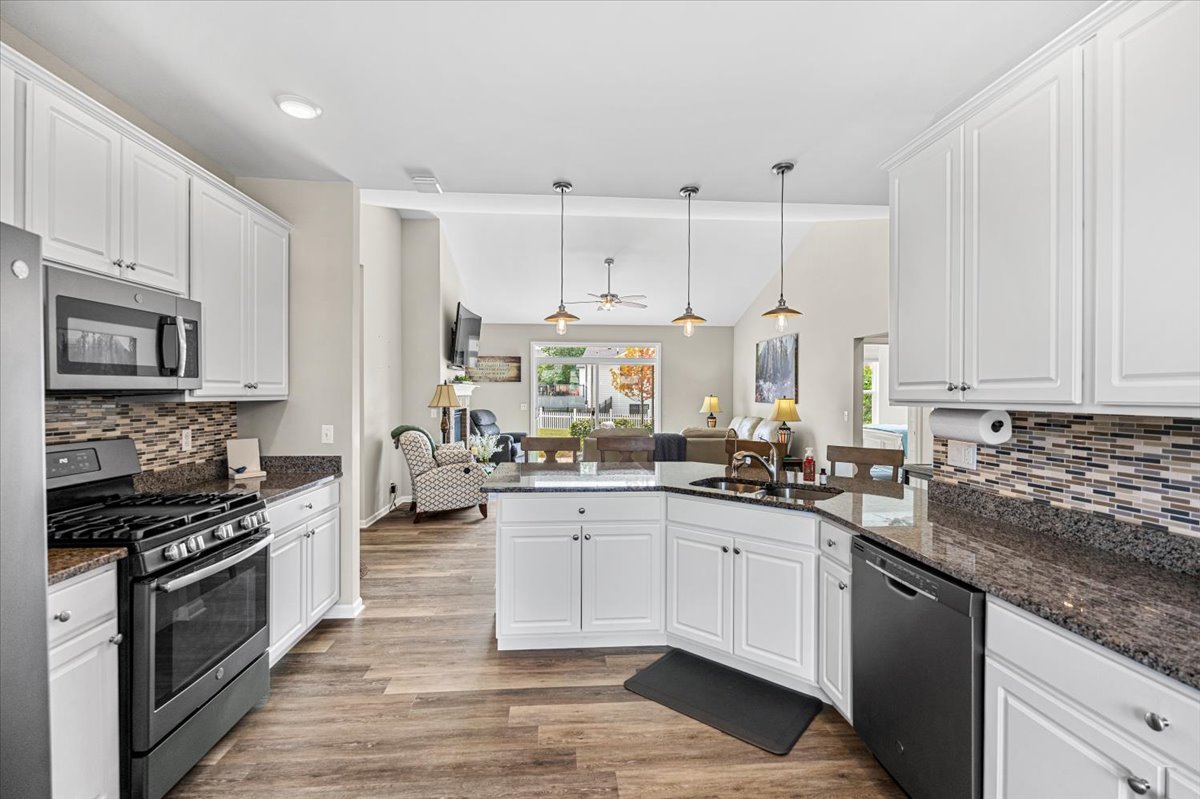 2220 Tyler Trail McHenry, IL 60051 - Photo 2 of 24 a kitchen with stainless steel appliances granite countertop a stove top oven a sink a counter space and cabinets