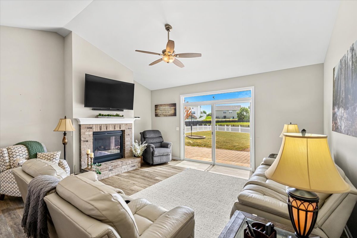 2220 Tyler Trail McHenry, IL 60051 - Photo 3 of 24 a living room with furniture a fireplace and a flat screen tv