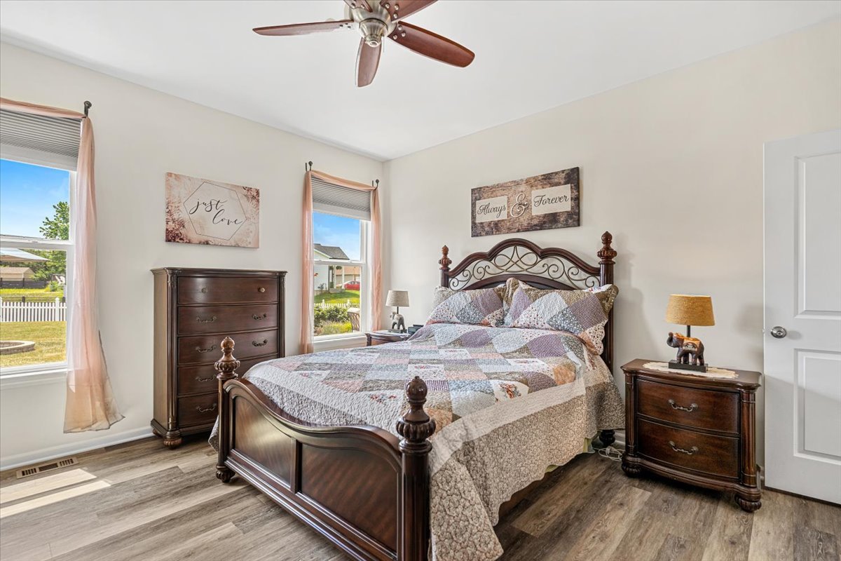 2220 Tyler Trail McHenry, IL 60051 - Photo 9 of 24 a bedroom with a bed and a chandelier