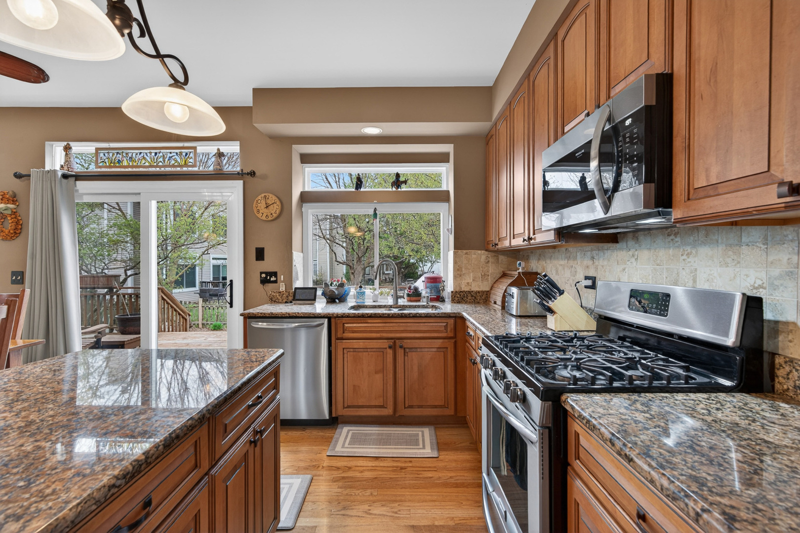 1160 Heavens Gate Lake In The Hills, IL 60156 - Photo 18 of 49 a kitchen with stainless steel appliances granite countertop a stove and a sink