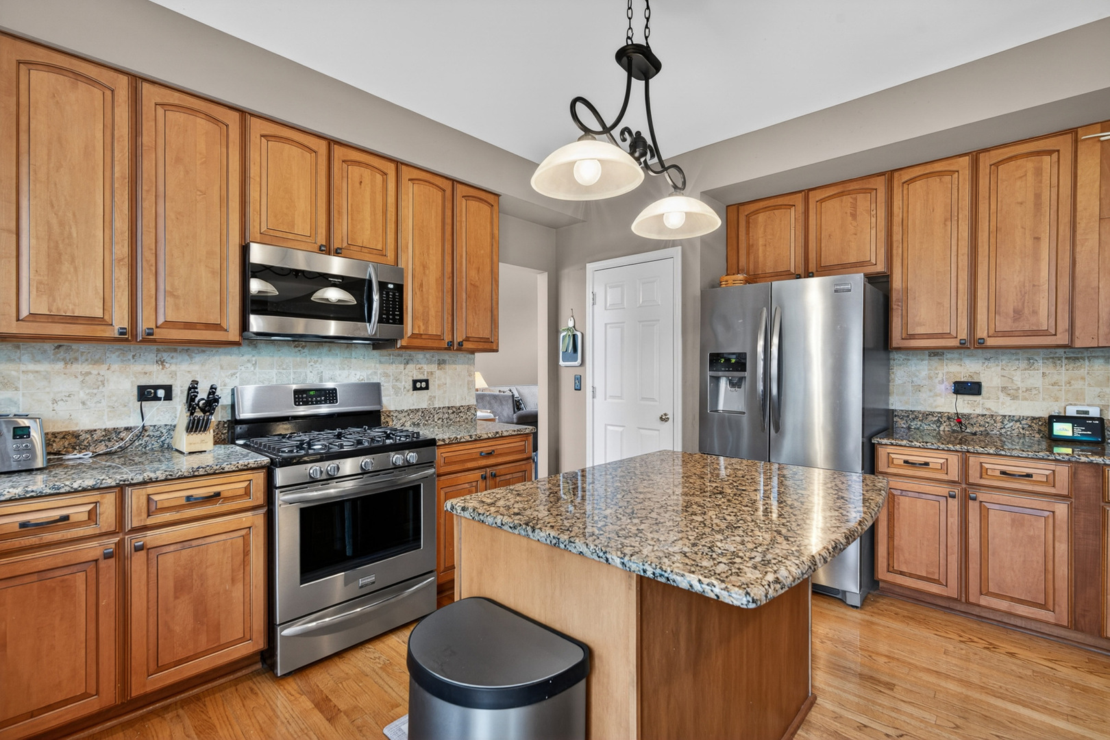 1160 Heavens Gate Lake In The Hills, IL 60156 - Photo 20 of 49 a kitchen with stainless steel appliances granite countertop a stove refrigerator sink and microwave