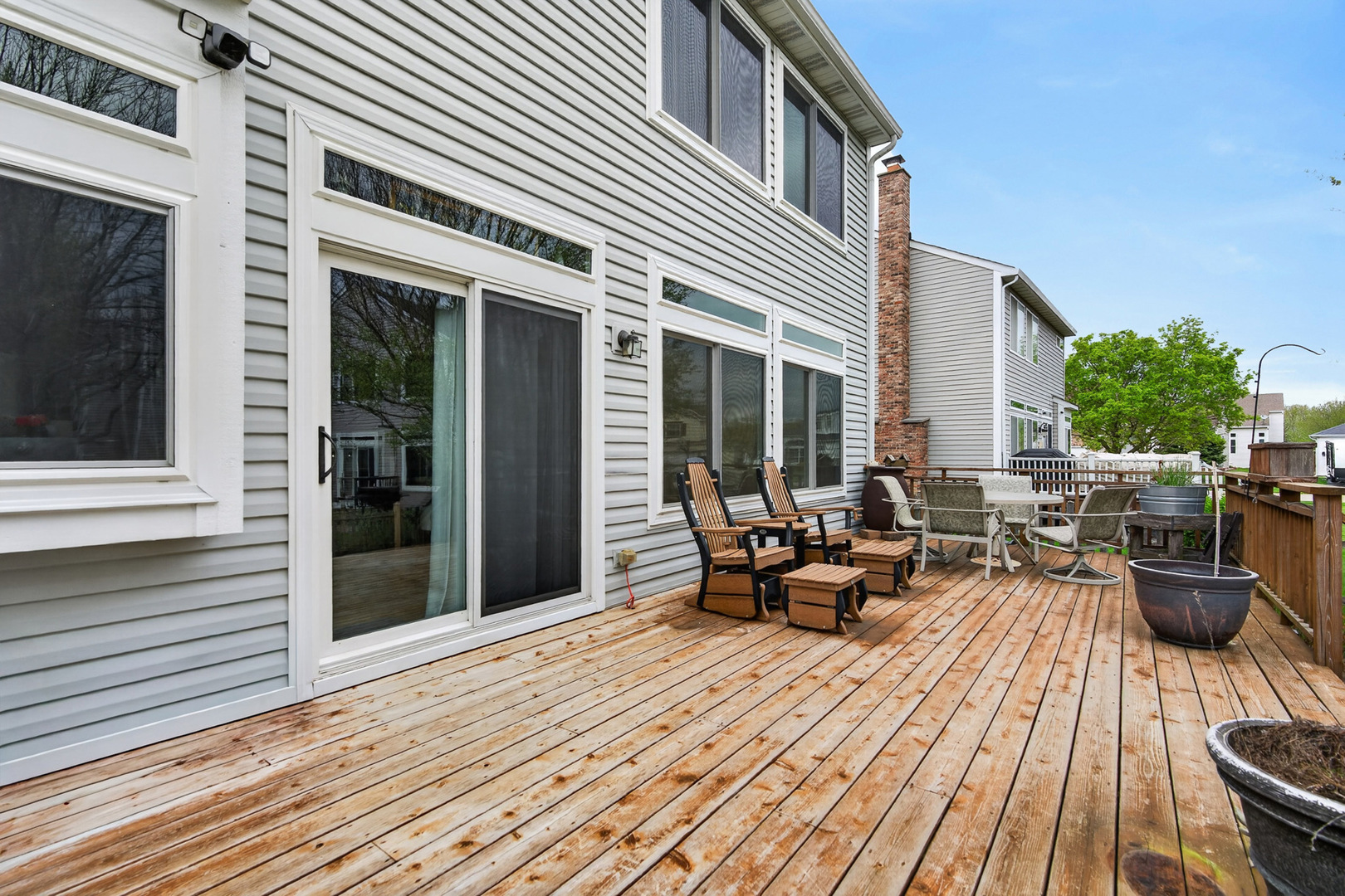 1160 Heavens Gate Lake In The Hills, IL 60156 - Photo 45 of 49 a view of a patio with couches table and chairs and wooden floor