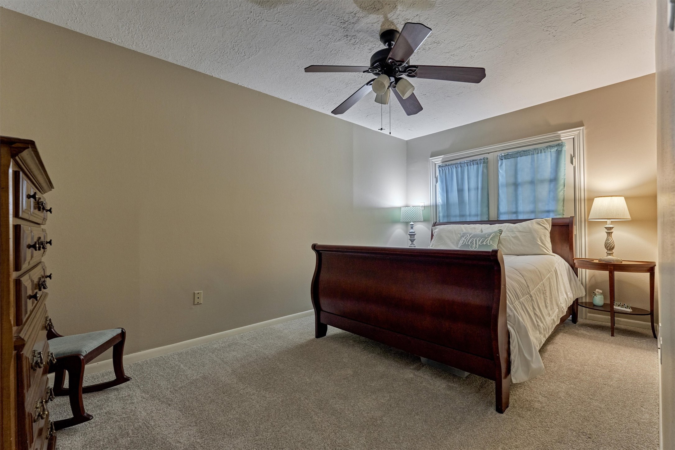 39 Regency Point Conroe, TX 77356 - Photo 10 of 44 a bedroom with a bed and a chandelier