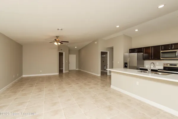 a view of a kitchen with a sink and cabinets
