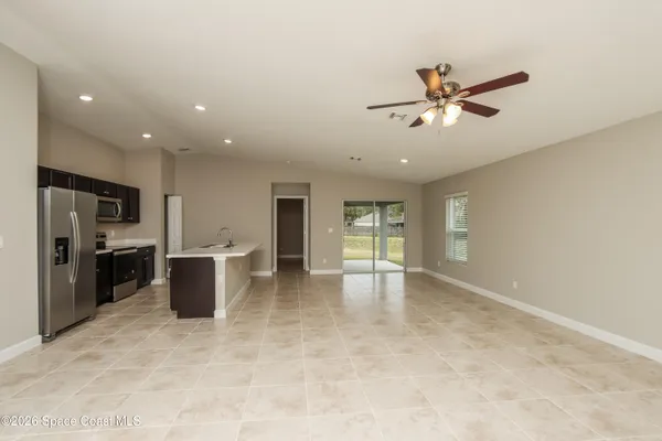 a view of a kitchen with furniture and a ceiling fan