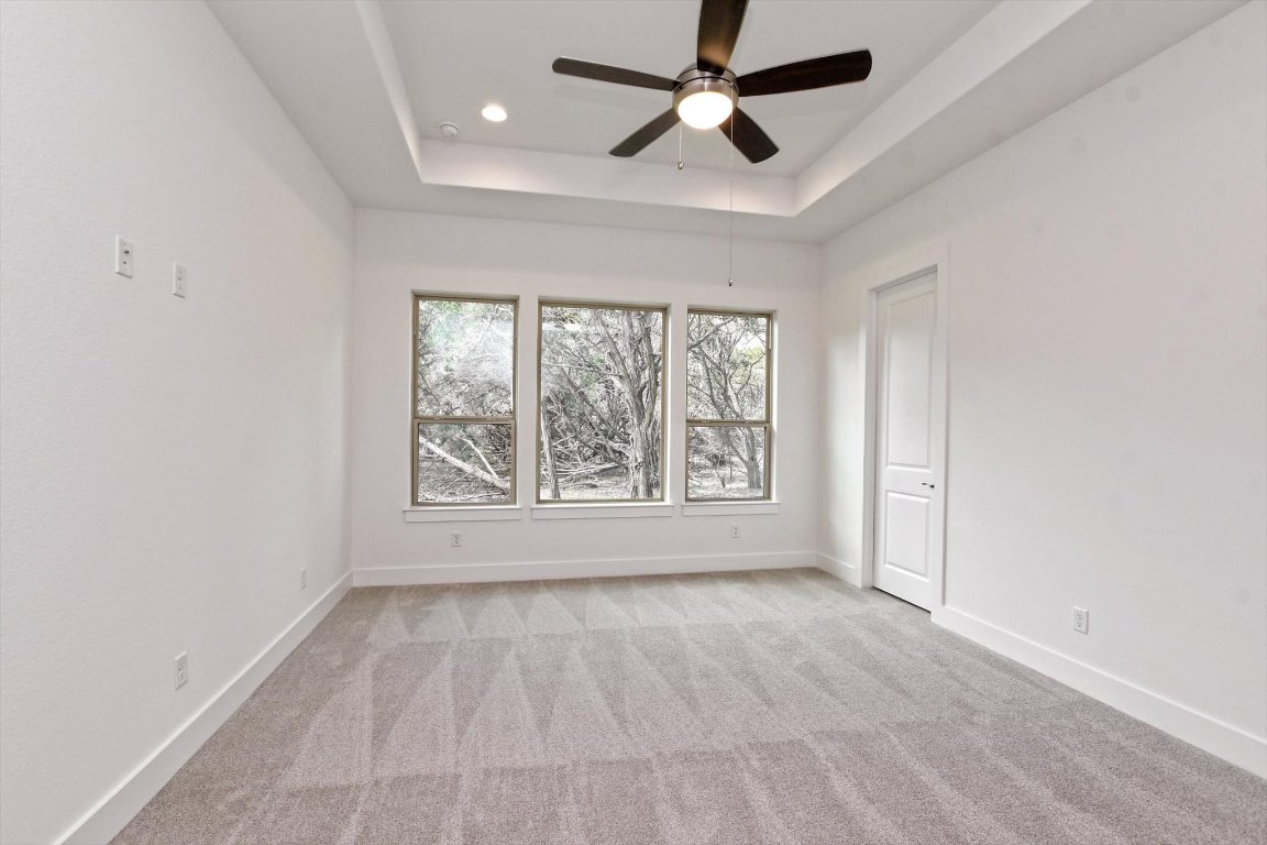 4828 Destination Way Jonestown, TX 78645 - Photo 14 of 33 wooden floor in an empty room with a window