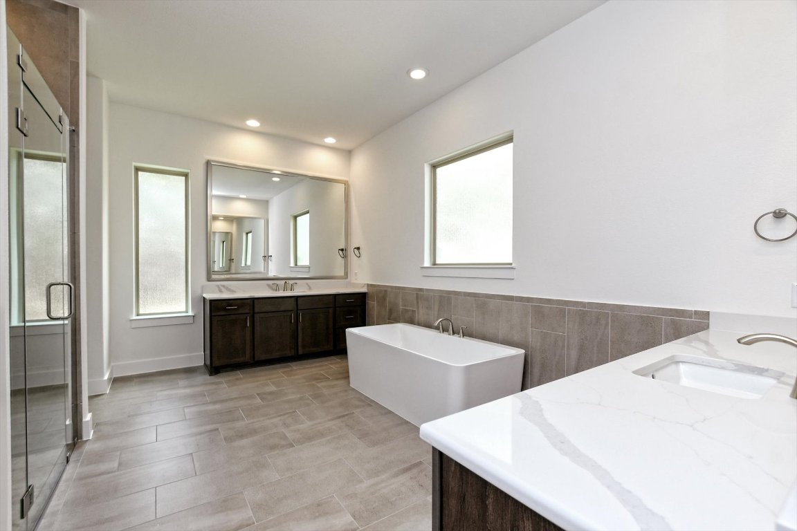 4828 Destination Way Jonestown, TX 78645 - Photo 19 of 33 a kitchen with a sink and a refrigerator