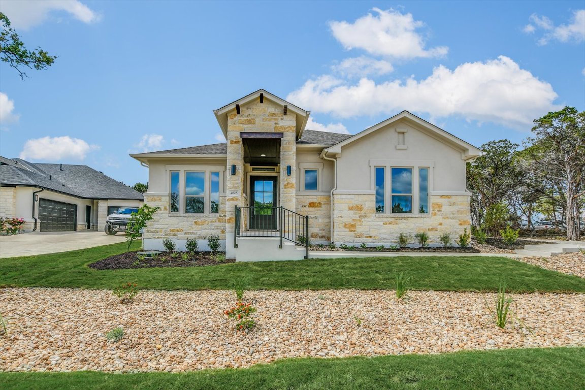 4828 Destination Way Jonestown, TX 78645 - Photo 2 of 33 a front view of a house with a yard and garage