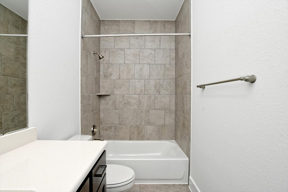 4828 Destination Way Jonestown, TX 78645 - Photo 28 of 33 a bathroom with a sink a toilet and shower