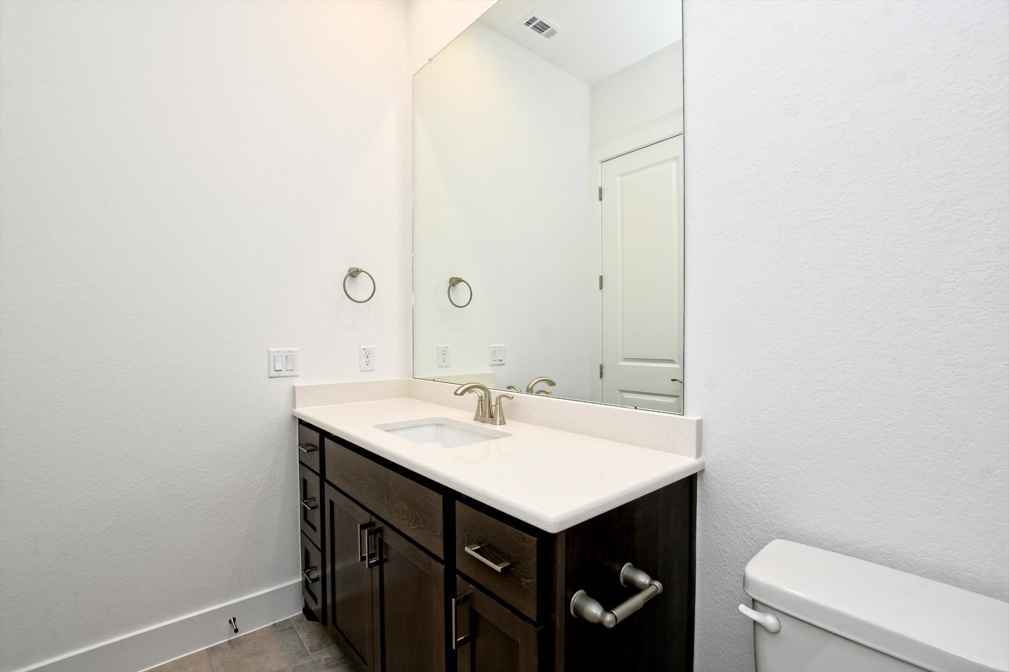 4828 Destination Way Jonestown, TX 78645 - Photo 29 of 33 a bathroom with a sink a toilet and a mirror