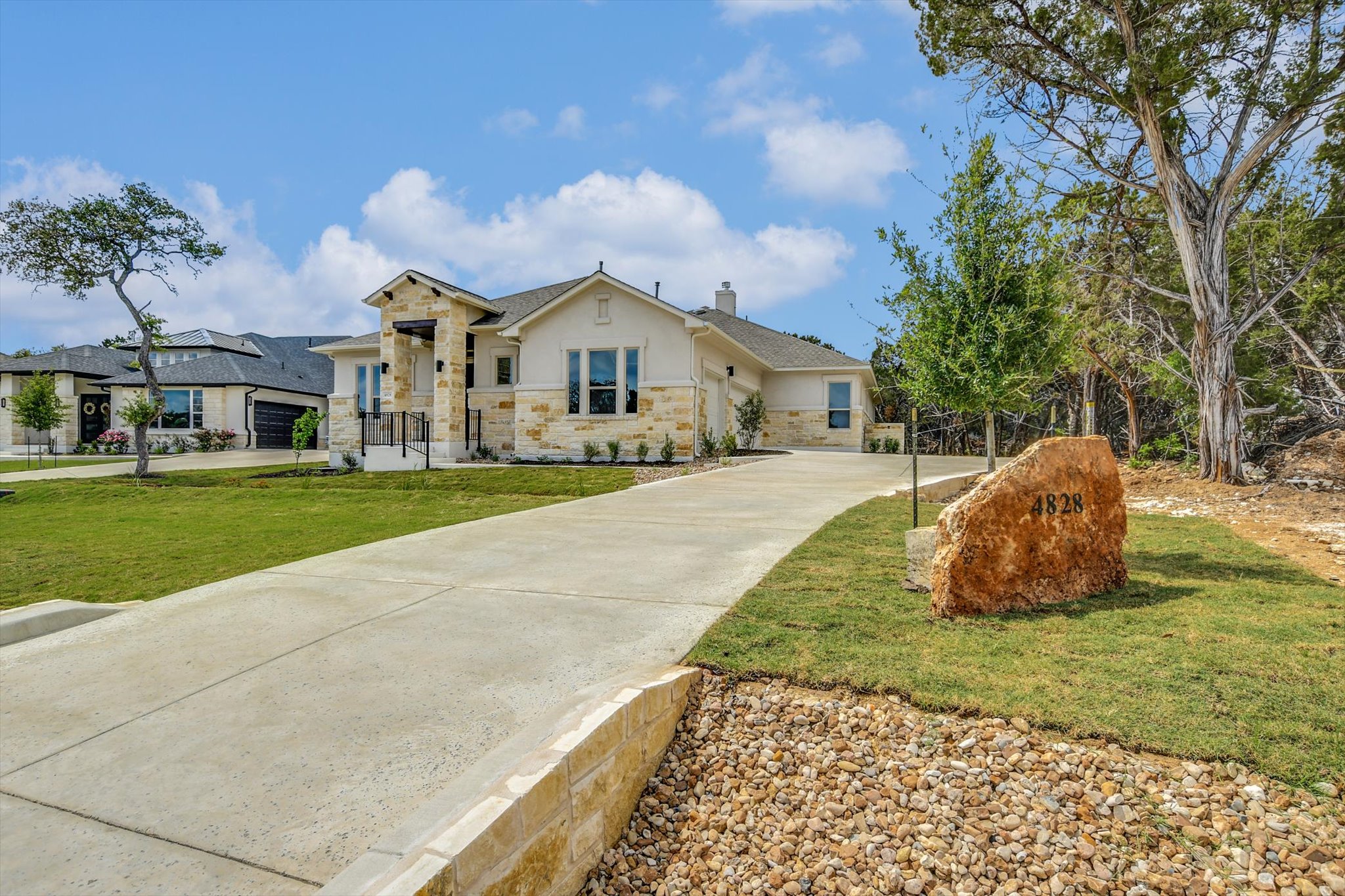 4828 Destination Way Jonestown, TX 78645 - Photo 3 of 33 a view of a white house with a yard and sitting area