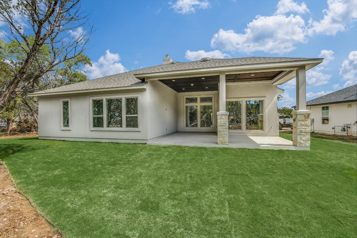 4828 Destination Way Jonestown, TX 78645 - Photo 32 of 33 a view of a house with a backyard