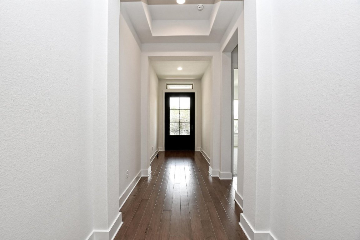 4828 Destination Way Jonestown, TX 78645 - Photo 4 of 33 a view of hallway with wooden floor