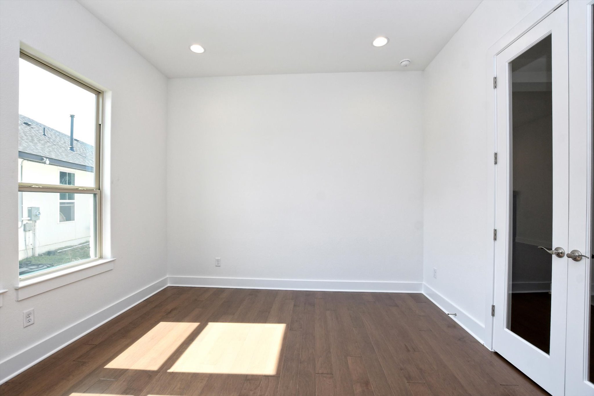 4828 Destination Way Jonestown, TX 78645 - Photo 5 of 33 a view of an empty room with wooden floor and a window