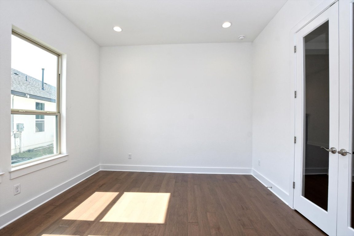 4828 Destination Way Jonestown, TX 78645 - Photo 5 of 33 a view of an empty room with wooden floor and a window