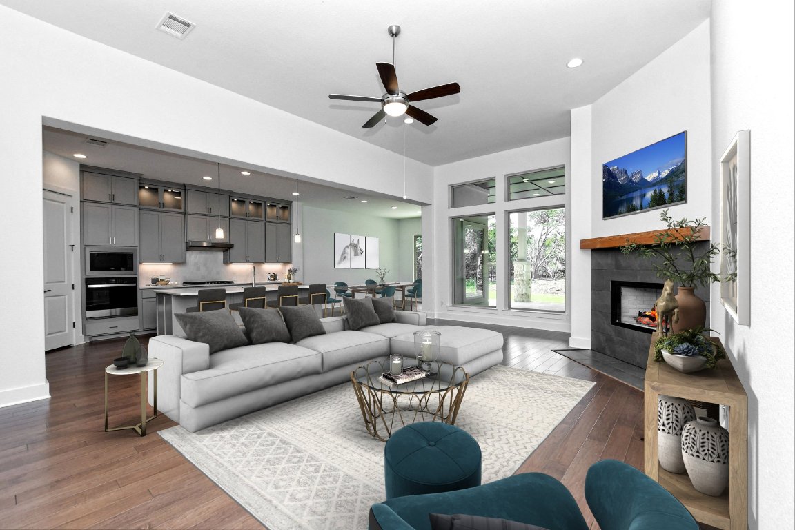 4828 Destination Way Jonestown, TX 78645 - Photo 7 of 33 a living room with furniture fireplace and flat screen tv