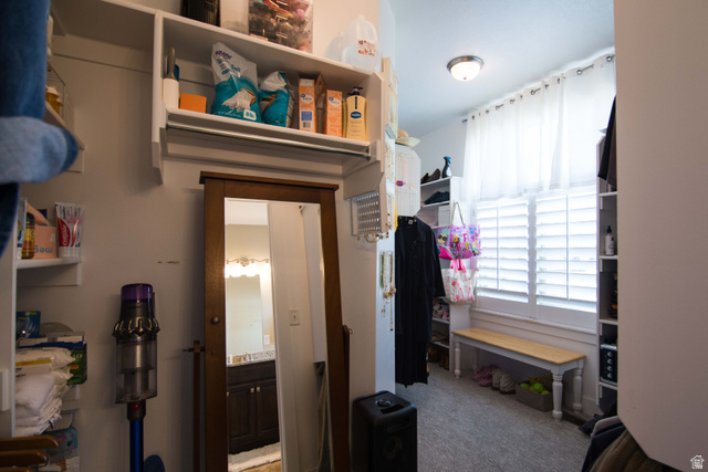 646 East 1400th Street North Mapleton, UT 84664 - Photo 58 of 78 Walk-in closet featuring white built-in shelving, a full-length mirror, a window with white shutters, a wood-top bench, and recessed lighting