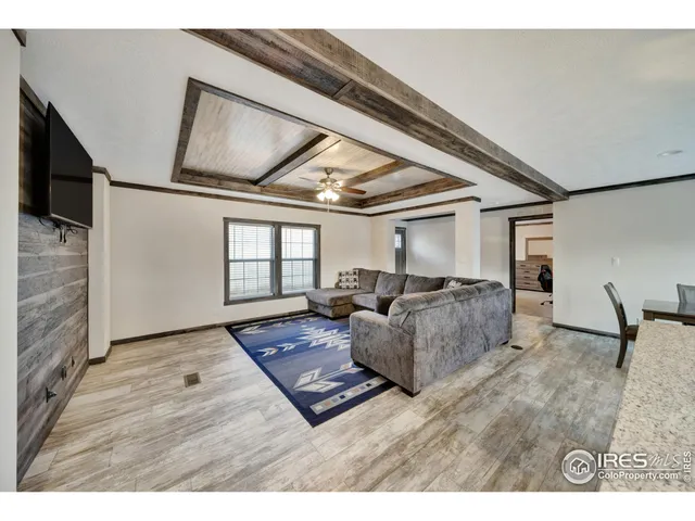 a living room with furniture and large window