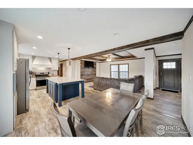 a kitchen with kitchen island a sink counter top space and stainless steel appliances