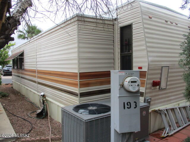 3100 South Kinney Road, Unit 193 Tucson, AZ 85713 - Photo 21 of 35 a front view of a house with exposed pipes and a tree