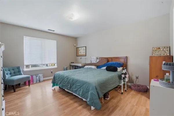 a bedroom with a bed and a chair