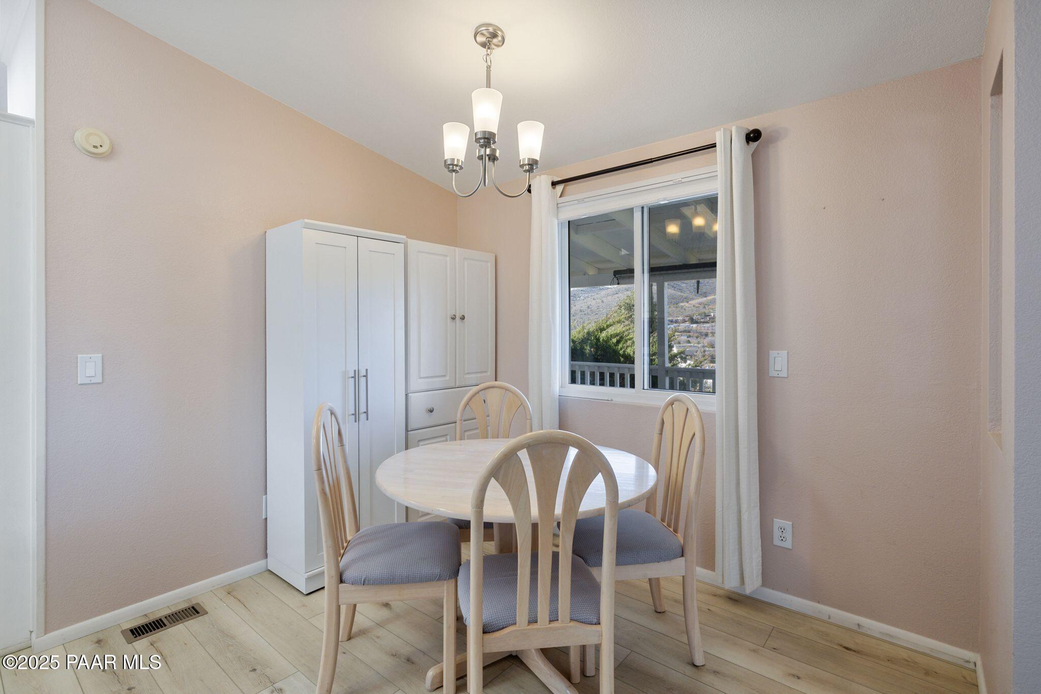 2572 Hilltop Road Prescott, AZ 86301 - Photo 20 of 34 a view of a dining room with furniture window and wooden floor
