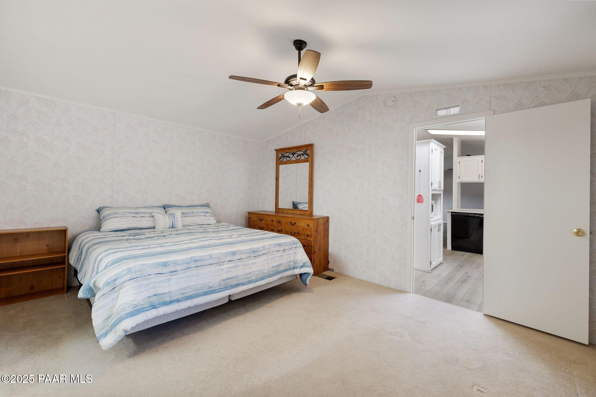 2572 Hilltop Road Prescott, AZ 86301 - Photo 26 of 34 a bedroom with bed and a chandelier