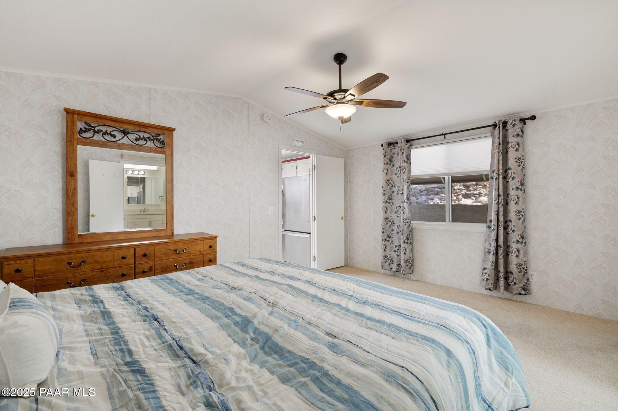 2572 Hilltop Road Prescott, AZ 86301 - Photo 27 of 34 a bedroom with a large bed dresser and a window
