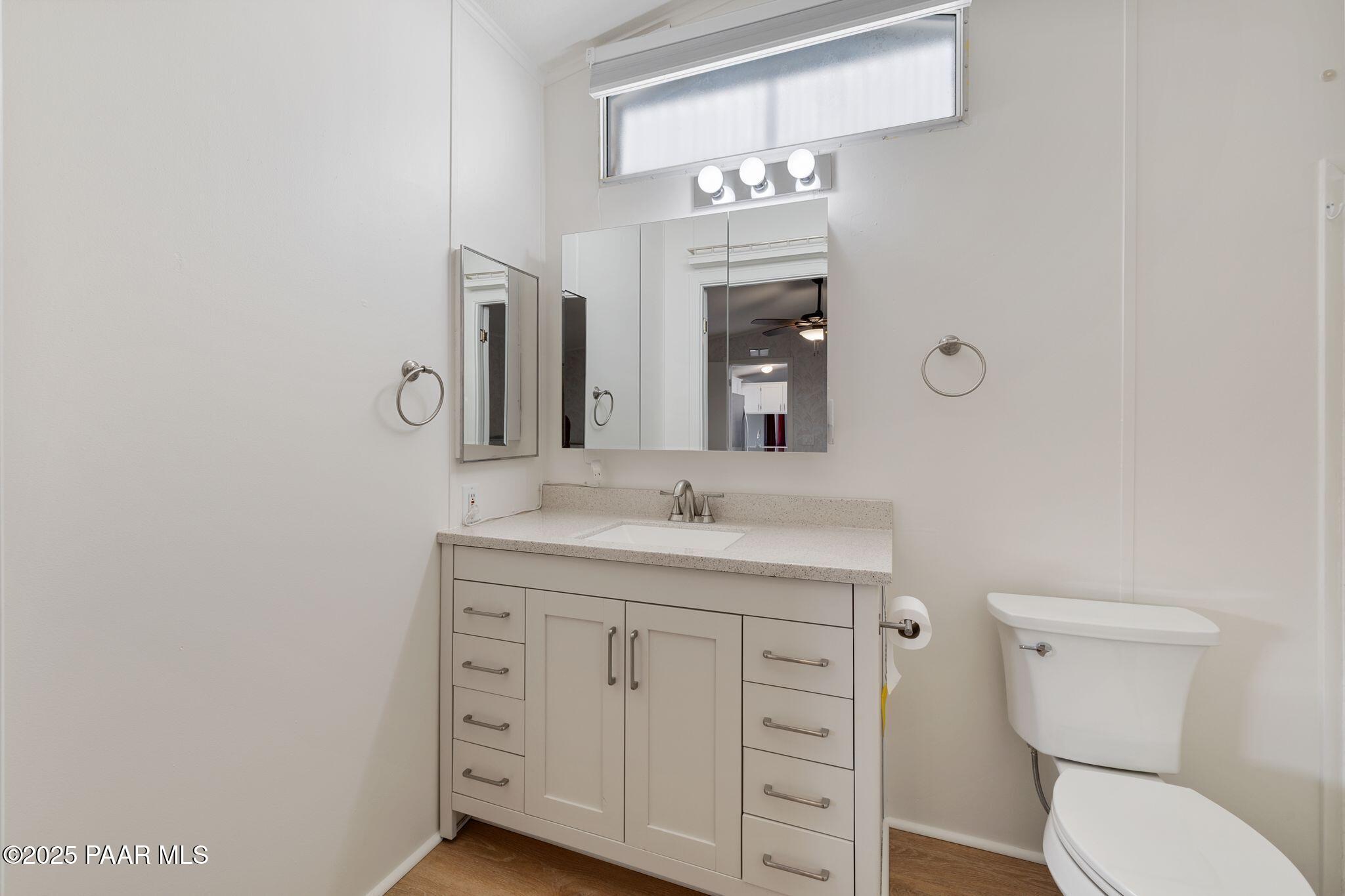 2572 Hilltop Road Prescott, AZ 86301 - Photo 28 of 34 a spacious bathroom with a granite countertop toilet a sink and a mirror