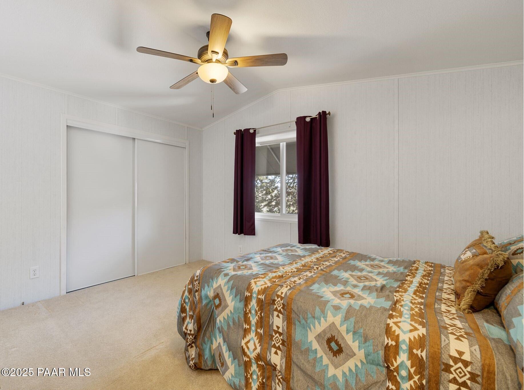 2572 Hilltop Road Prescott, AZ 86301 - Photo 30 of 34 a bedroom with a large bed and a window