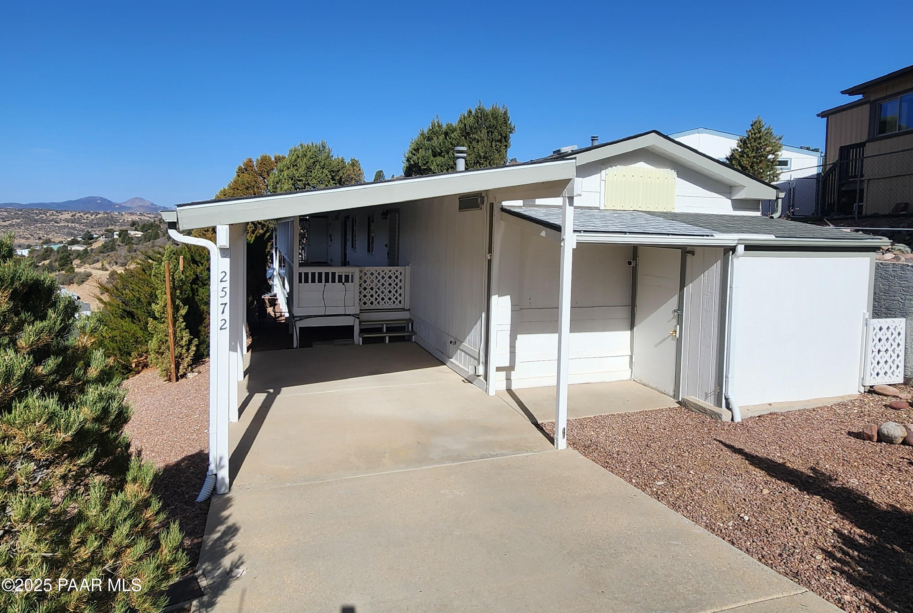 2572 Hilltop Road Prescott, AZ 86301 - Photo 3 of 34 a view of a house with a porch and furniture