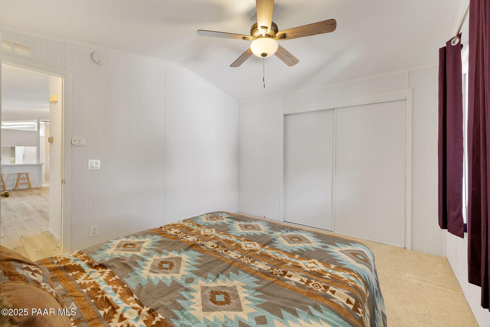 2572 Hilltop Road Prescott, AZ 86301 - Photo 31 of 34 a bedroom with a bed and a chandelier