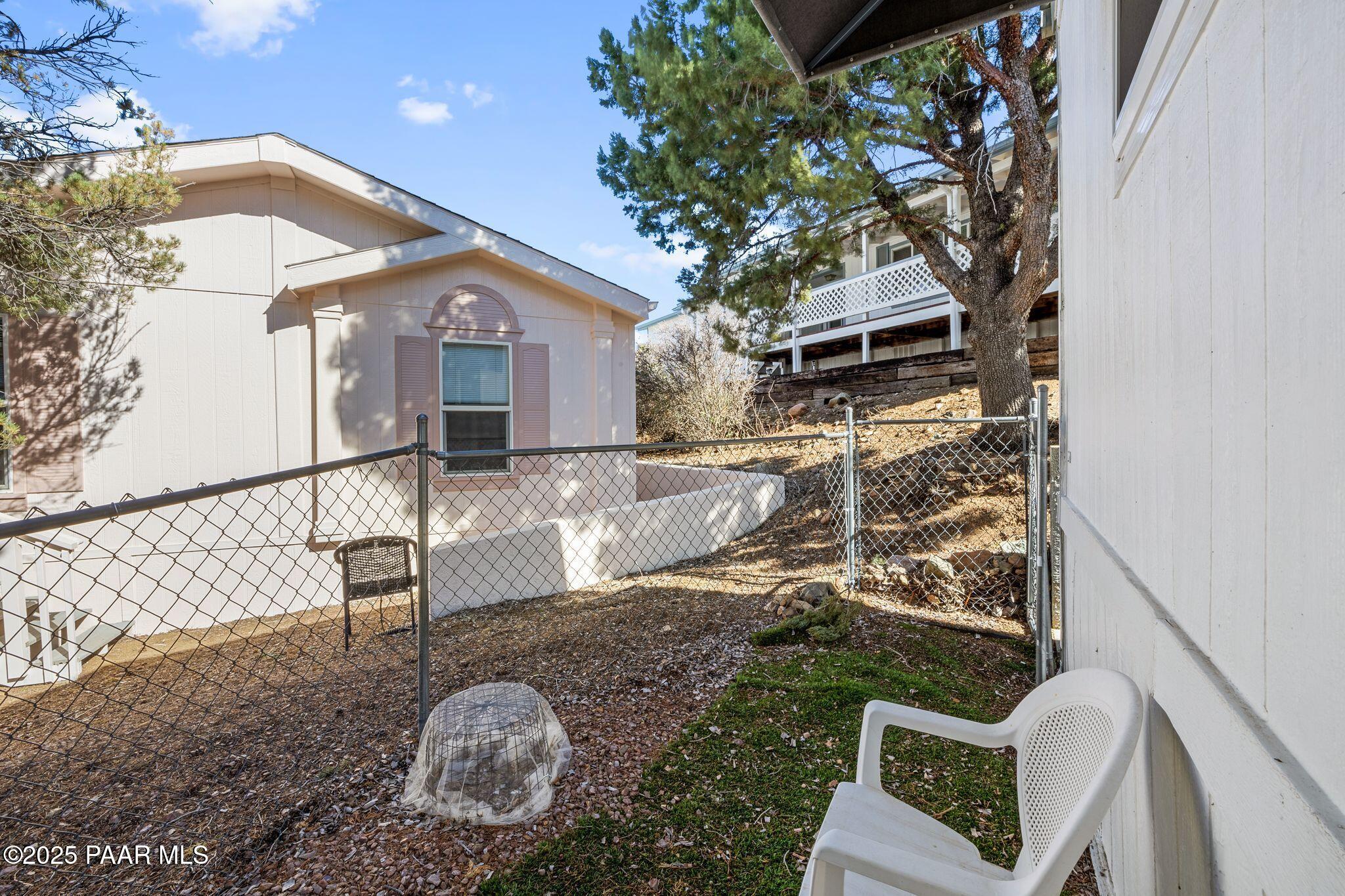 2572 Hilltop Road Prescott, AZ 86301 - Photo 33 of 34 a backyard of a house with table and chairs
