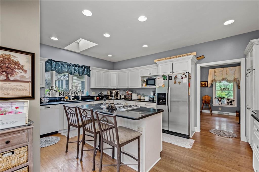 230 Sundust Road Eighty Four, PA 15330 - Photo 8 of 47 a kitchen with stainless steel appliances a dining table chairs and wooden floor