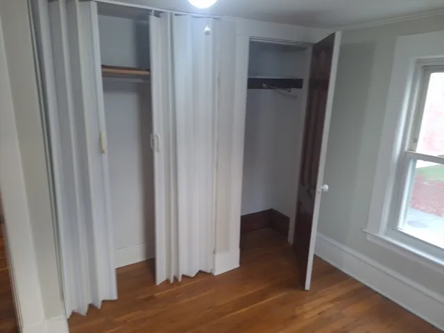 a view of bedroom with a closet and wooden floor