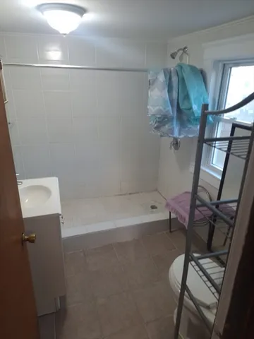 a bathroom with a bathtub a toilet and a shower