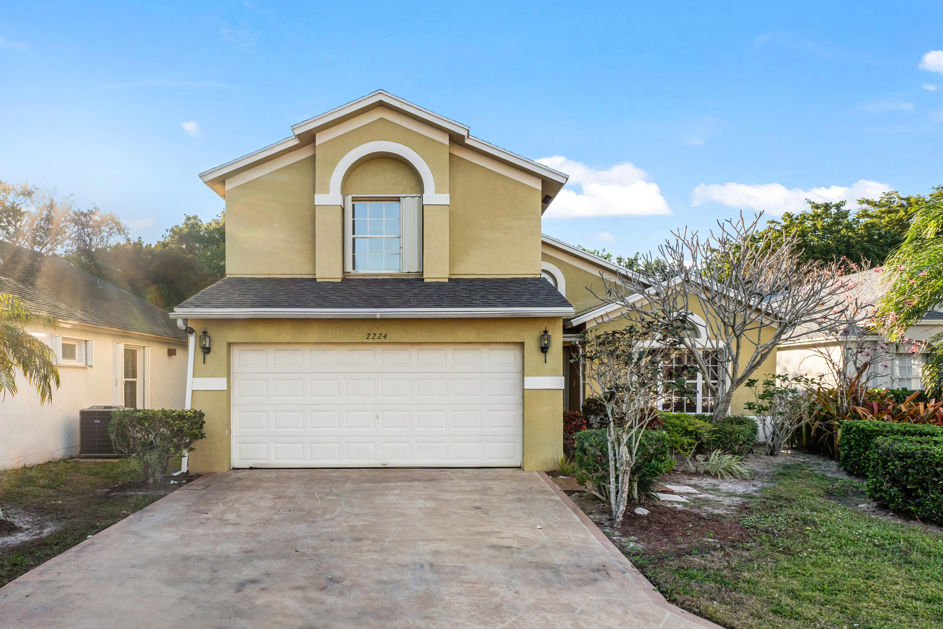 2224 Soundings Court Greenacres, FL 33413 - Photo 2 of 46 a front view of a house with a yard and garage