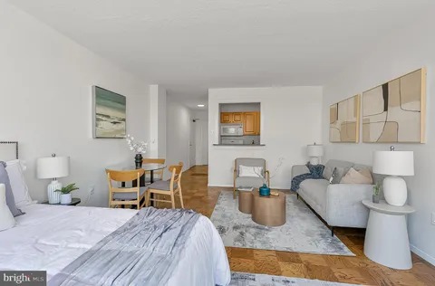 a bedroom with furniture and a rug