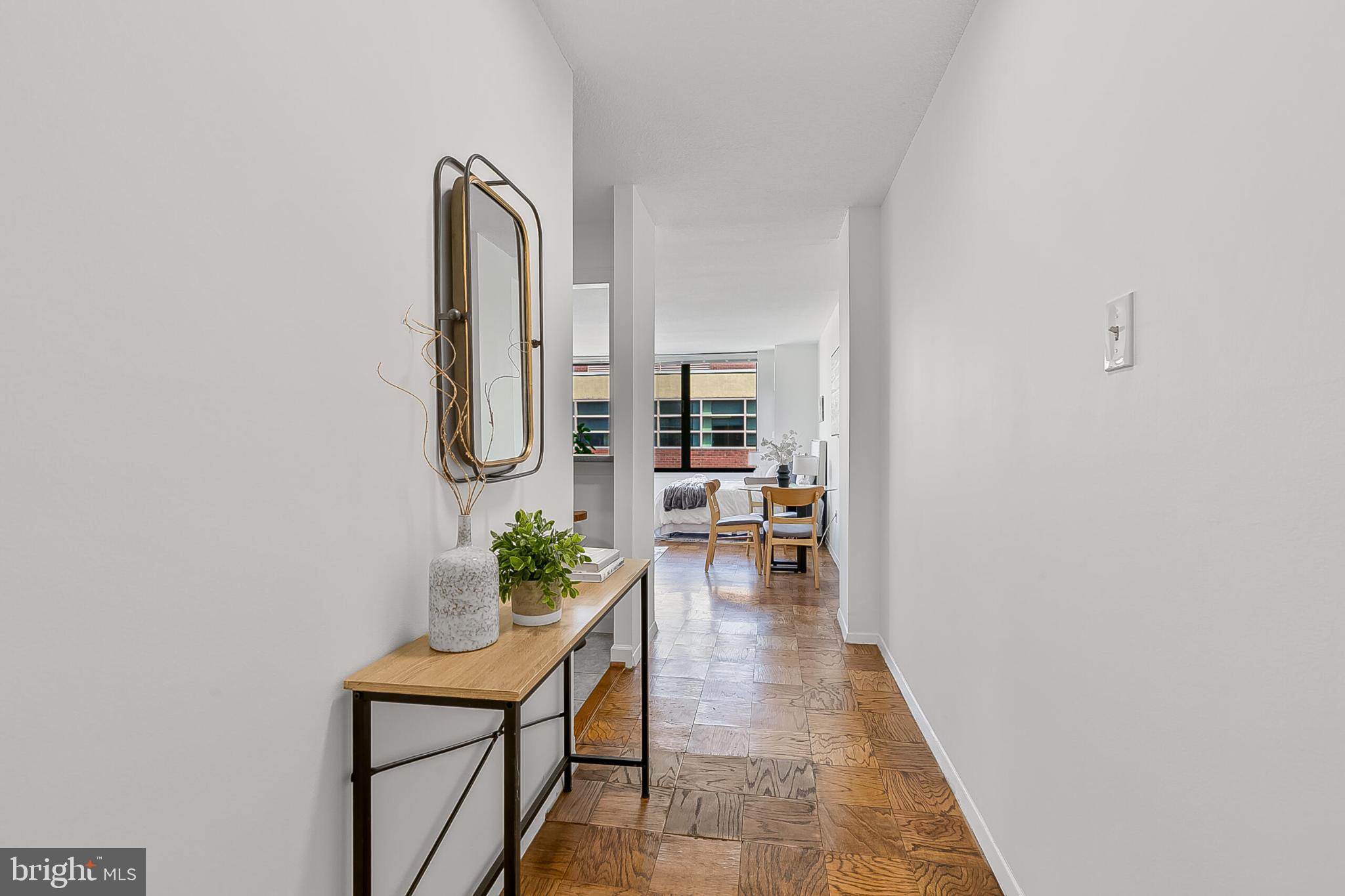 1301 20th Street Northwest, Unit 901 Washington, DC 20036 - Photo 17 of 26 an entryway with a potted plant on a table and a potted plant