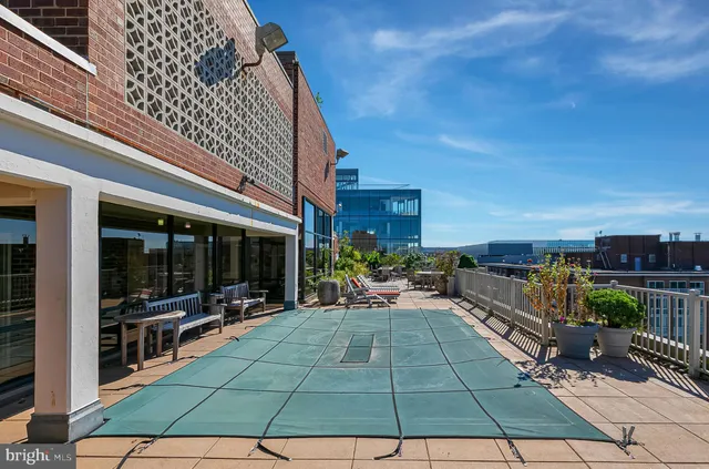 a view of a patio with table and chairs a barbeque with wooden floor and fence
