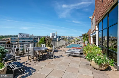 a view of roof deck with patio and garden
